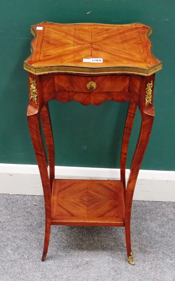 A mid-19th century French gilt metal mounted tulipwood occasional table, the shaped top over single frieze drawer on slender cabriole supports, united