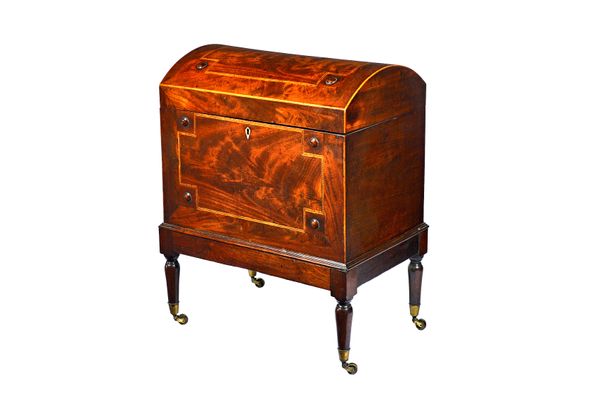A George III inlaid mahogany dome top cellarette, on turned supports and castors, 50cm wide x 63cm high x 34cm deep.