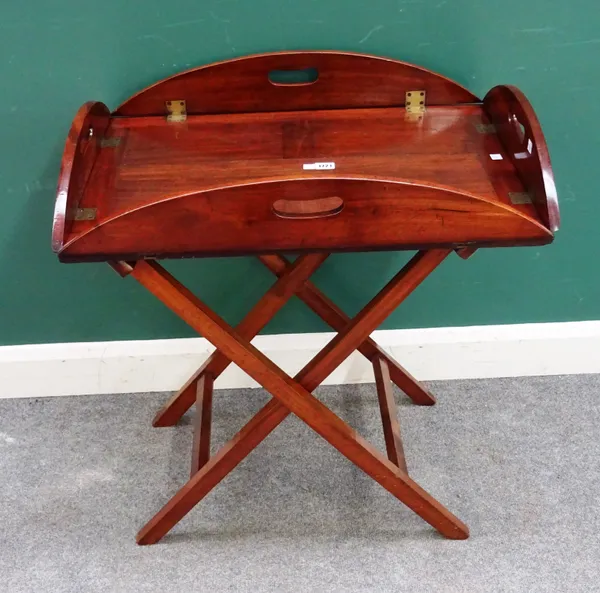 A George III mahogany drop flap rectangular butler's tray, with pierced loop handles and folding stand, 72cm wide x 81cm high x 51cm deep.