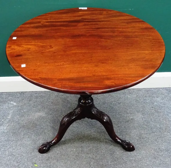 A mid-18th century mahogany occasional table, the circular snap top on turned and spiral turned column and carved tripod base, resting on claw and bal