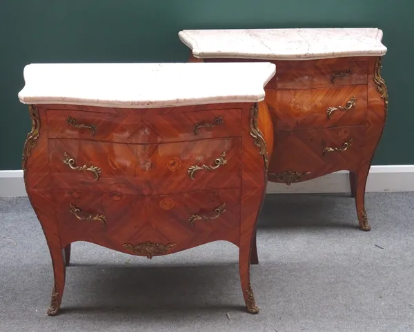 A pair of Louis XV style commodes, each with serpentine marble top over a gilt metal mounted floral marquetry inlaid bombé Kingwood three drawer base,