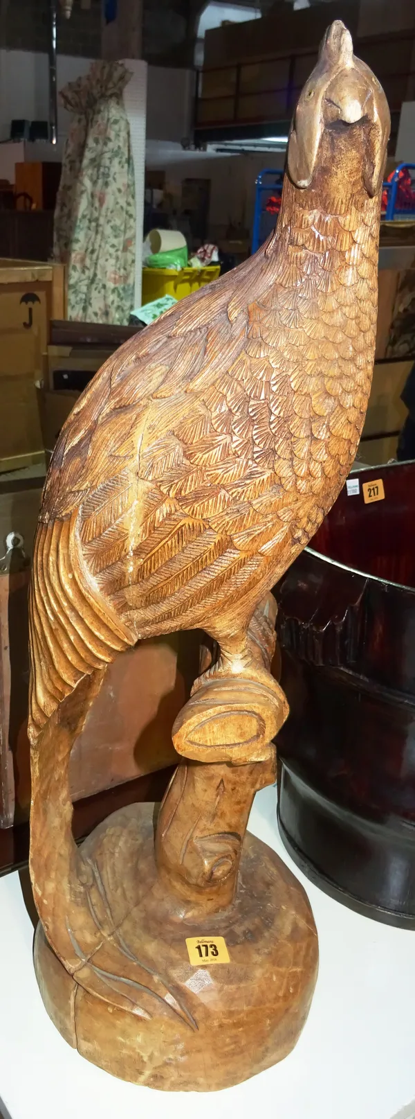 A 20th century carved hardwood model of a pheasant, 70cm wide.  M2