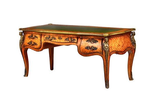 A Louis XV style gilt metal mounted parquetry inlaid Kingwood bureau plat, the leather inset serpentine shaped top over a bombé five drawer frieze, wi