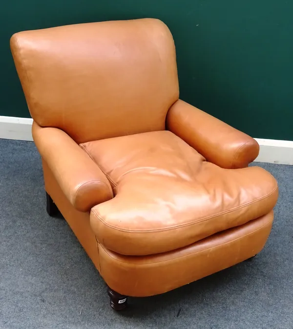 A 20th century light tan leather upholstered easy armchair, with bow seat on turned mahogany supports, 85cm wide x 82cm high.