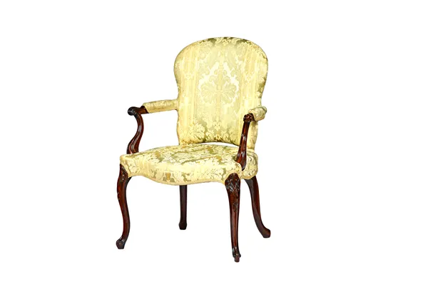 A George III mahogany framed open armchair, with serpentine seat on shell capped scroll supports, 66cm wide x 96cm high.  Illustrated