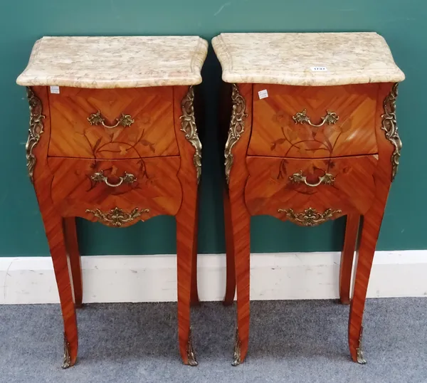 A pair of Louis XV style bedside tables, each with serpentine marble top over a gilt metal mounted floral marquetry inlaid Kingwood bombé two drawer b
