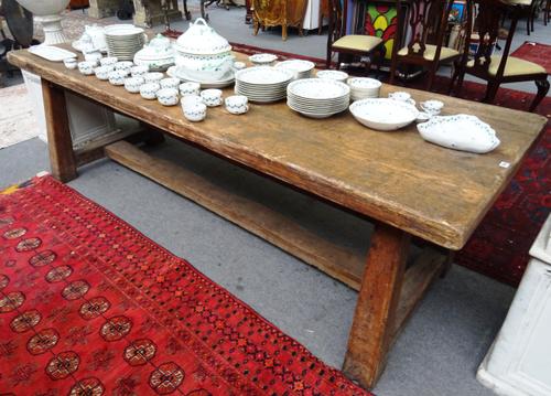 A large oak kitchen table, the rectangular top on four splayed oak supports united by stretcher, 93cm wide x 275cm long x 81cm high, the top 7cm thick