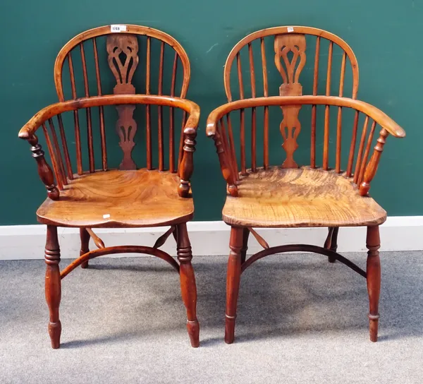 A Harlequin set of four mid-18th century yew wood and elm Windsor chairs, each with pierced splat back and solid seat, on turned supports, united by c