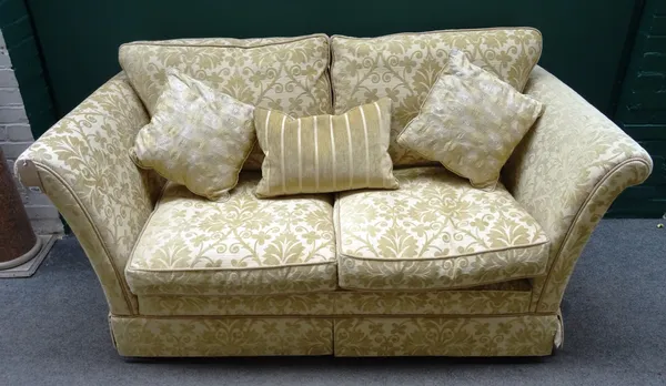 A 20th century square back two seater sofa, with outswept arms and gold stylised floral pattern upholstery, 185cm wide x 93cm deep x 80cm high.