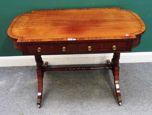 A Regency mahogany centre writing table with double 'D' end top over pair of frieze drawers, with dummy verso, on turned columns and four downswept su
