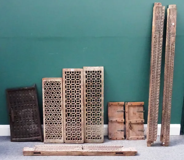 Three sections of a 19th century carved hardwood door frame, three painted hardwood Jali screens, each approximately 24cm wide x 88cm high, a pair of