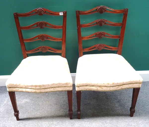 A set of six George II style mahogany shell carved wavy ladder back dining chairs, on fluted tapering square supports, each 57cm wide x 92cm high, (6)