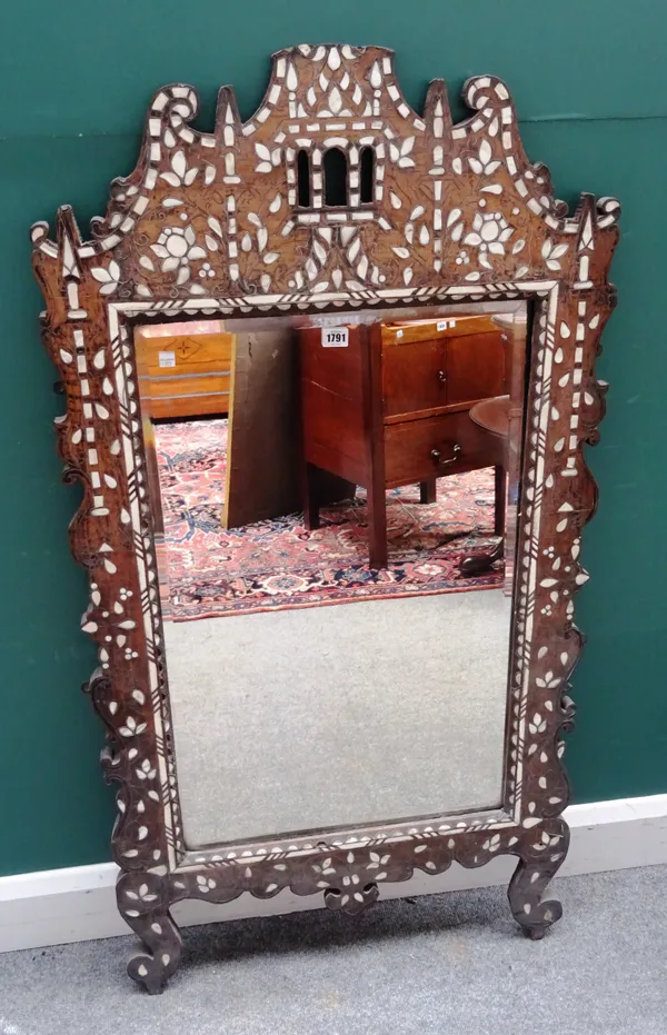 An early 20th century Damascus and mother-of-pearl inlaid hardwood mirror, with shaped frame about the bevelled mirror plate, 69cm wide x 132cm high.