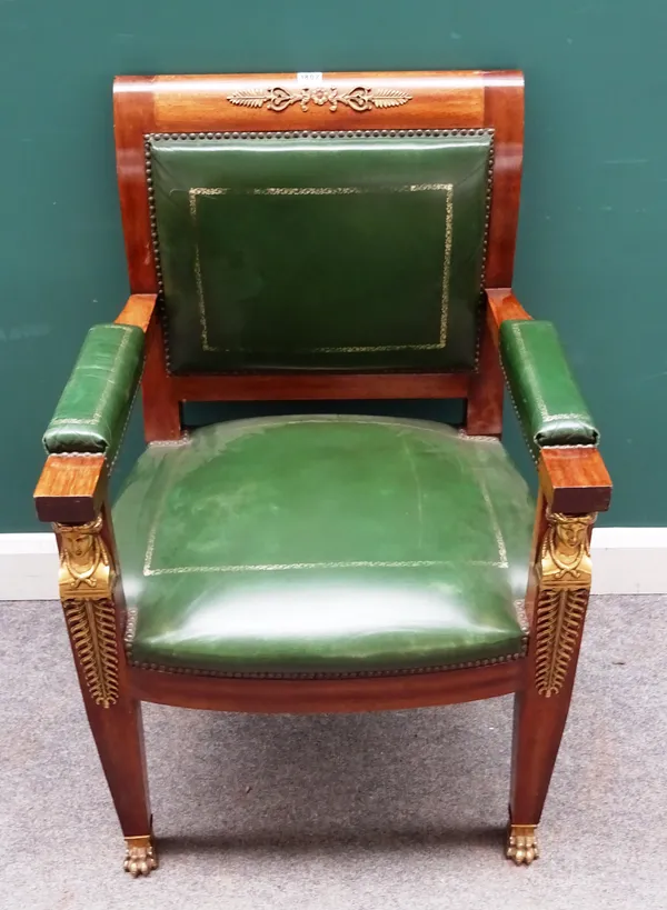 An Empire style gilt metal mounted mahogany open armchair, with caryatid front supports, on gilt metal paw feet, 63cm wide x 95cm high.