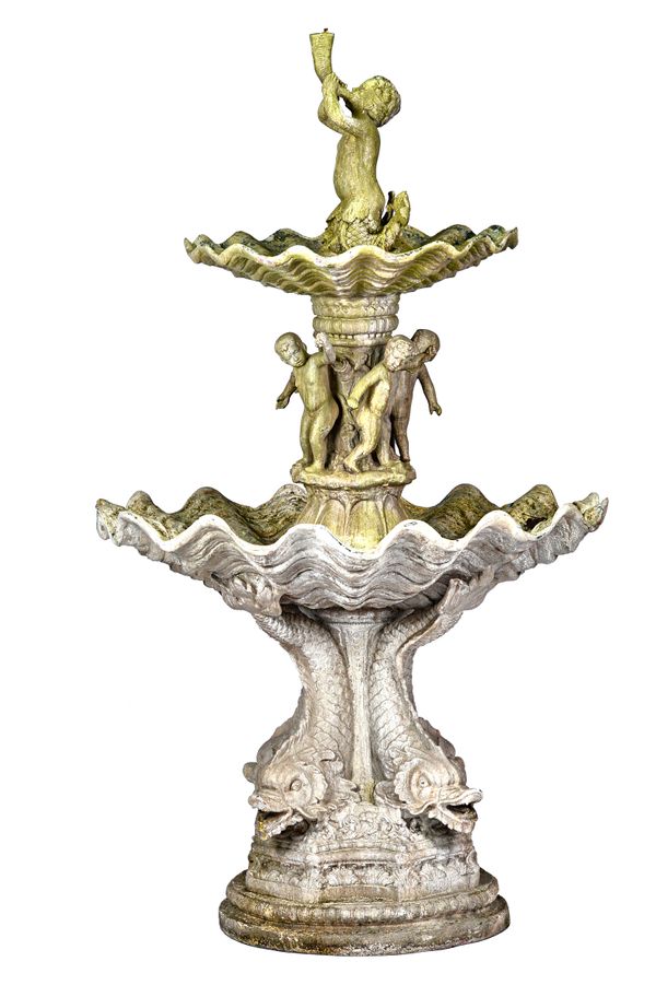 A fibreglass stone effect two tier water fountain, the top spout modelled as a cherub mermaid blowing a cornucopia above a scalloped reservoir, the na