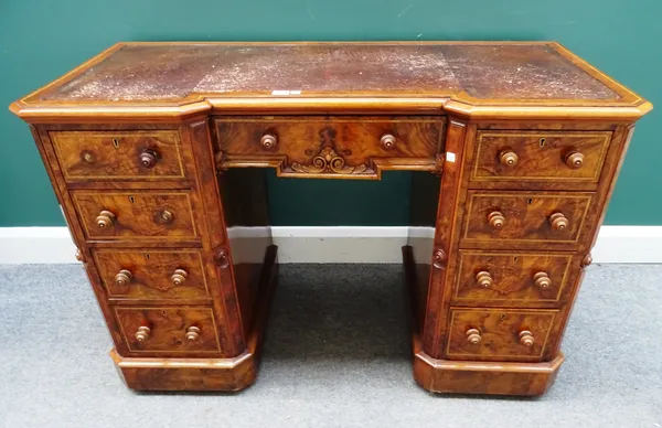 A pair of mid-19th century satinwood banded figured walnut writing desks, each with inverted breakfront leather inset top over nine drawers about the