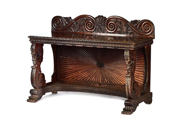 A mid-19th century Anglo-Indian teak console table, the carved ledge back over rectangular top with carved frieze, on a pair of open carved 'S' scroll