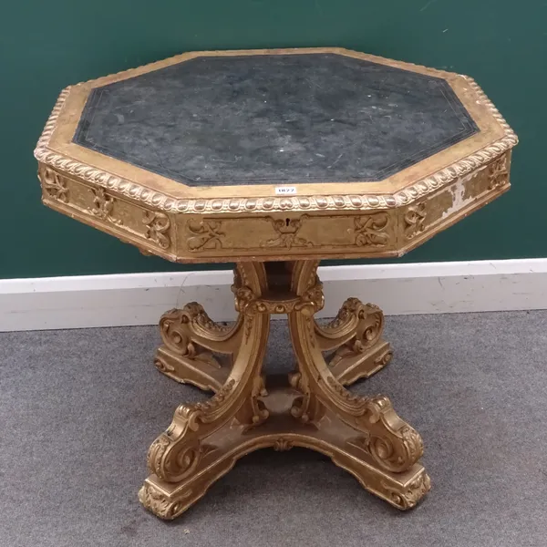 A 19th century gilt octagonal centre table, the gadrooned moulded frieze with four drawers (two fitted), on four open downswept supports and scroll fe