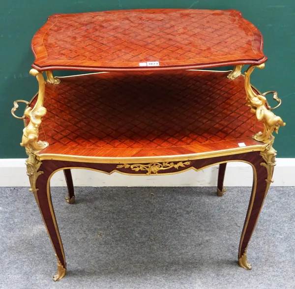 A Louis XV style French gilt metal mounted parquetry inlaid Kingwood and tulipwood shaped two tier etagere with recumbent cherub supports on slender c