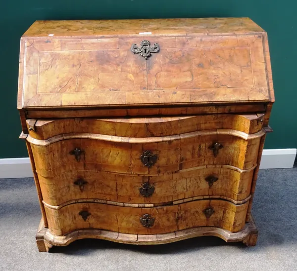 An 18th century German figured walnut bureau, the fitted welled interior over three long serpentine drawers, on bracket feet, 109cm wide x 101cm high