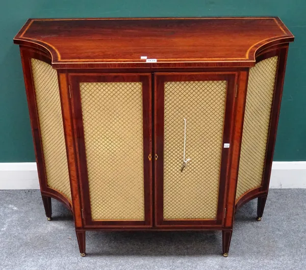 A late 18th century satinwood banded rosewood side cabinet, with pair of central doors flanked by swept side doors, all with brass grille panels, on t