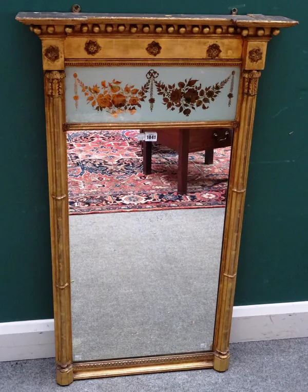A Regency gilt framed eglomise pier glass, the floral painted panel over rectangular mirror plate, flanked by cluster columns, 66cm wide x 110cm high.