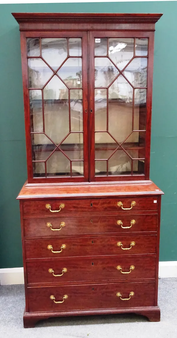 A George III mahogany secretaire bookcase chest, the pair of astragal glazed doors over a double fronted fitted drawer and three further long graduate