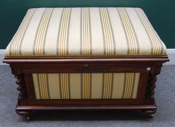An early Victorian rosewood framed lift top box ottoman, with overstuffed lid and side panels about the carved barleytwist supports, on turned bun fee