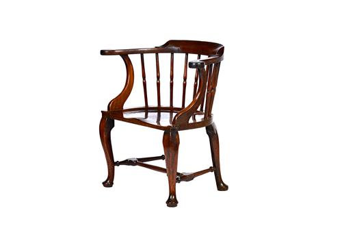 A George III mahogany low bow back Windsor chair, with waisted turned spindles and dished saddle seat with extended thumb moulded corners, on four cab