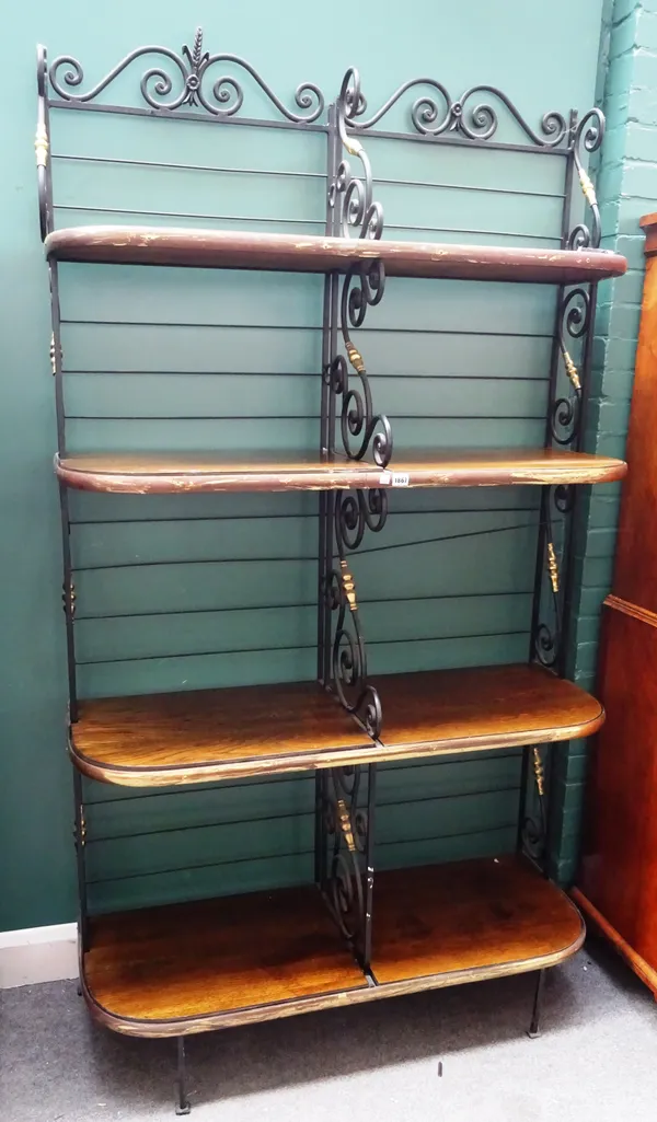 A 20th century wrought iron and lacquered brass waterfall four tier baker's rack with oak inset shelves, 120cm wide x 215cm high x 47cm deep.