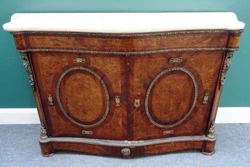 A pair of 19th century style side cabinets, each with serpentine marble top over a gilt metal mounted figured walnut and mahogany two door base, on sh