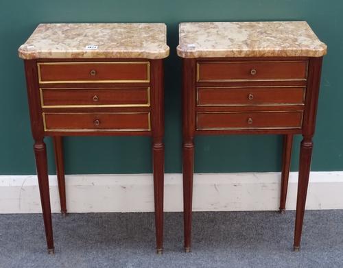 A pair of Louis XVI style petite commodes, each with shaped rectangular marble top over three frieze drawers, on tapering turned fluted supports, 41cm