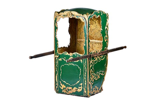 An 18th century style green painted parcel gilt sedan chair, 71cm wide x 155cm high x 75cm deep.   Illustrated