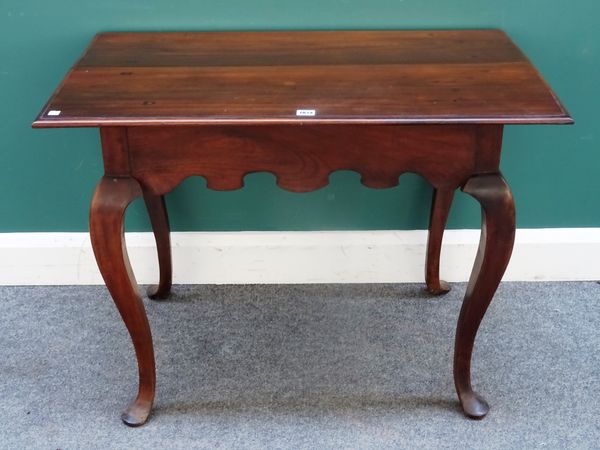 A late 18th/early 19th century Anglo-Portuguese rosewood centre table, the rectangular plank top over shaped frieze and square cabriole supports, 94cm