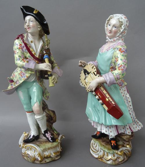 A pair of large Meissen porcelain figures of musicians, late 19th century, after Kaendler, incised 1351 and 1352 respectively, blue crossed swords mar