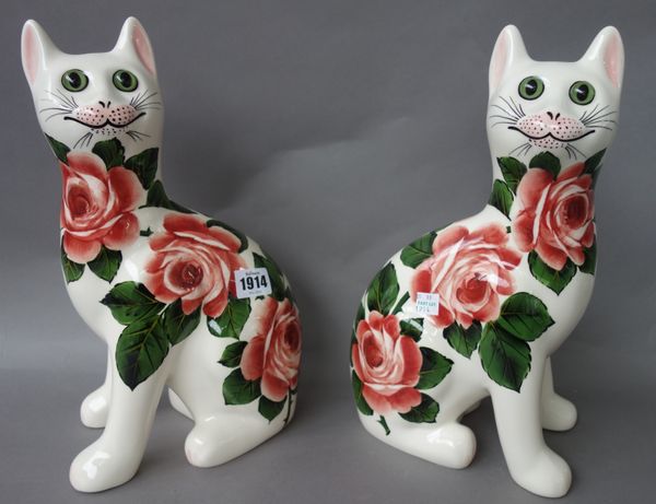 A pair of Griselda Hill pottery `Wemyss ware' cats, late 20th century, decorated with roses, painted marks. 33.5cm high. (2)