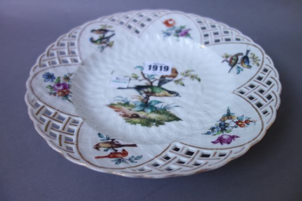 Ten German porcelain cabinet plates, late 19th century, decorated with exotic birds within a pierced border (23cm diameter) and two Meissen foliate de