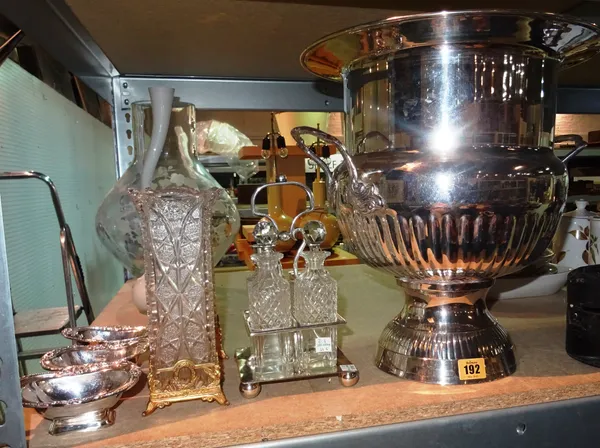 A large 20th century silver plated urn shaped wine cooler, a pair of gilt mounted glass vases, a four bottle condiment stand and three plated dishes,