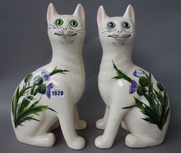 A pair of Griselda Hill pottery `Wemyss ware' cats, late 20th century, decorated with thistles, painted marks. 33.5cm high. (2)   Illustrated