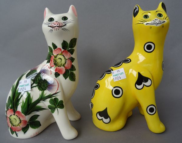 A pair of Griselda Hill pottery `Wemyss ware' cats decorated with thistles (17.5cm high) and two further, one decorated with roses, the other hearts a