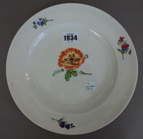 A Meissen porcelain plate, late 18th/19th century, painted with flowers against a white ground (23.5cm diameter), two later outside decorated Meissen