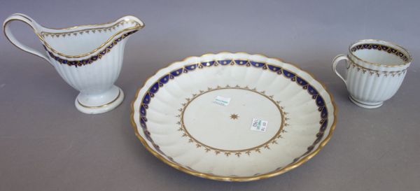 An early 20th century cut glass table lamp with domed shade (45cm high), a blue flashed cut glass square bowl, a pair of silver mounted decanters and