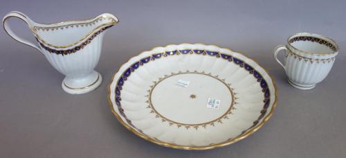 An early 20th century cut glass table lamp with domed shade (45cm high), a blue flashed cut glass square bowl, a pair of silver mounted decanters and