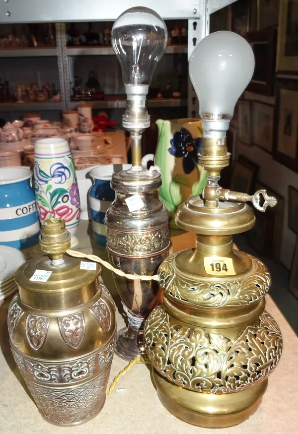 An early 20th century pierced brass table lamp, an Asian style table lamp and a silver plated table lamp, (3).  S3M