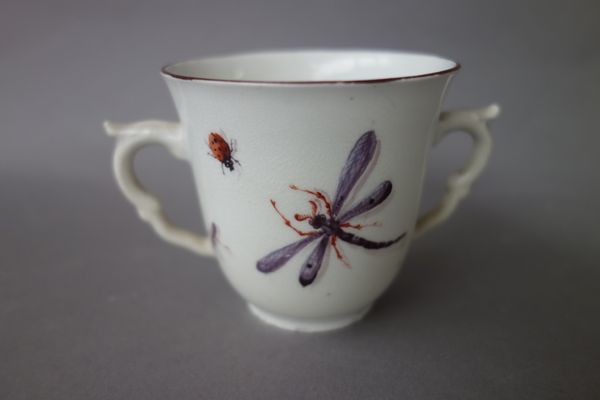 A Chelsea two-handled cup, red anchor period, circa 1755, painted with a bird in branches, the reverse painted  with insects, red anchor mark, remains