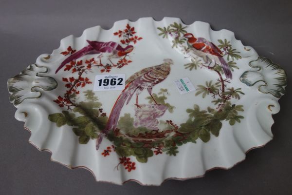 A Chelsea silver-shaped oval dish, circa 1758-60, painted with three exotic birds, shell moulded handles, brown anchor mark, (a.f), 25cm. wide.