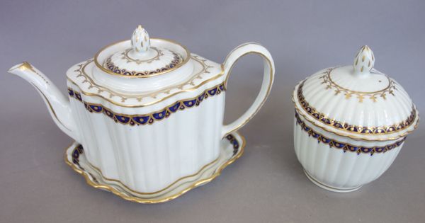 A New Hall fluted part tea service, circa 1785-90, painted in blue and gilt with pattern `155', comprising; a silver-shaped teapot, cover and stand, a