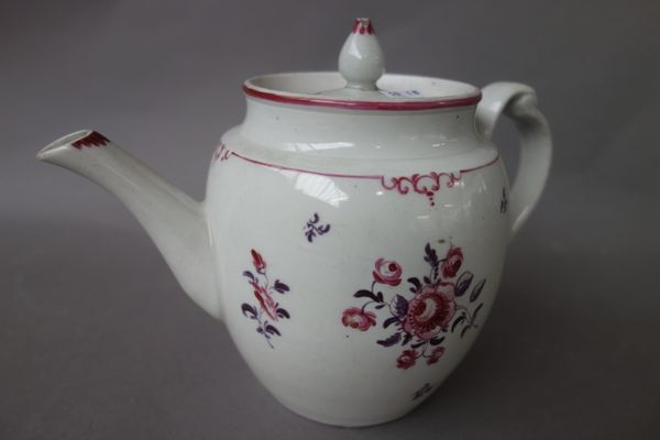 A New Hall barrel-shaped teapot and cover with clip handle, circa 1782-87, painted with flower sprays and sprigs in mauve and magenta, 15.2cm. high. I