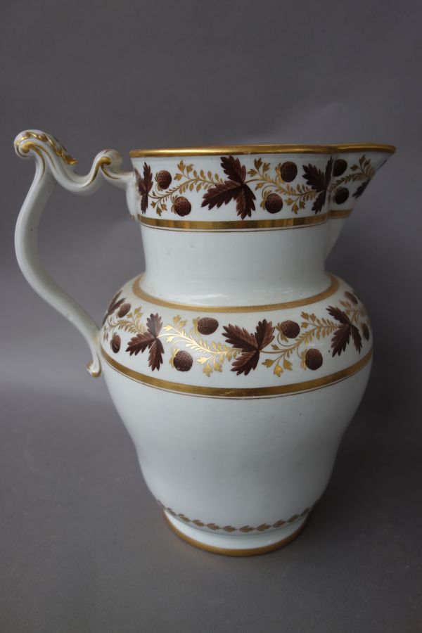 A New Hall-type water jug, circa 1800-1810, gilt with the initial D below bands of strawberries and leaves in brown and gilt, 24cm. high.