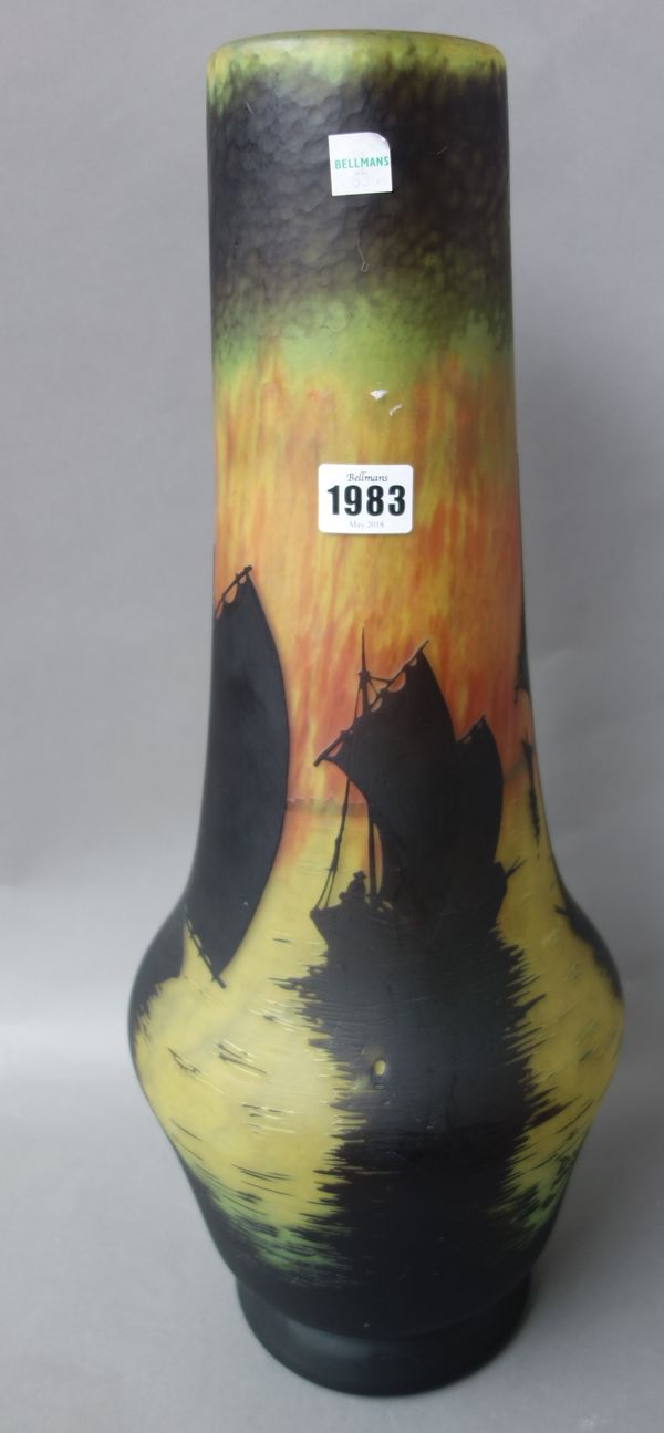 A Daum Nancy acid etched cameo vase, early 20th century detailed with ships silhouetted against a mottled yellow, orange and green ground, 52cm high,